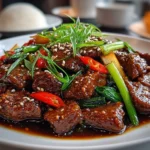Close-up slightly angled Szechuan Beef on white plate